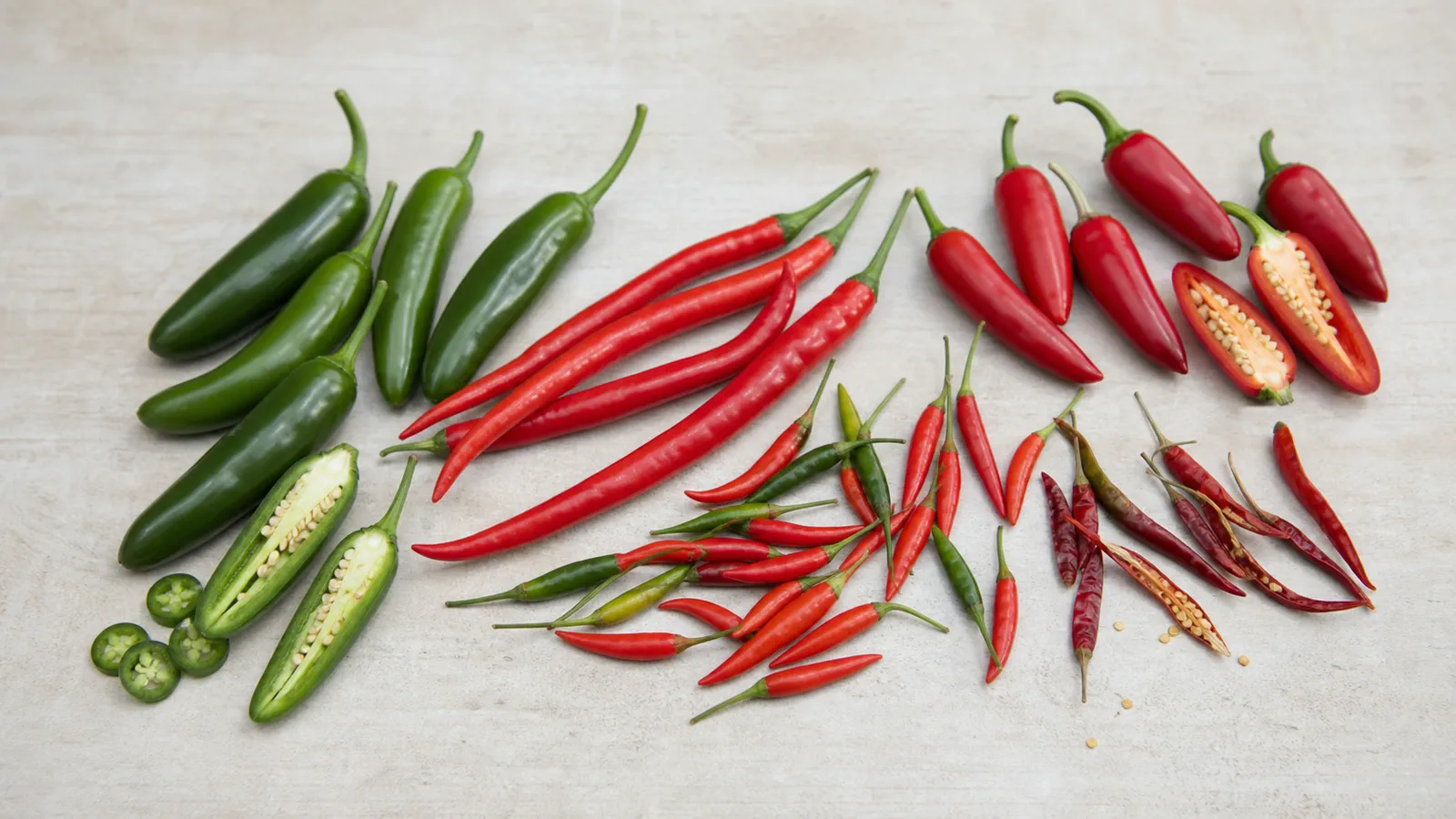 Hot-tier peppers arranged as a route overview with serrano, cayenne, Thai, and chile de arbol peppers